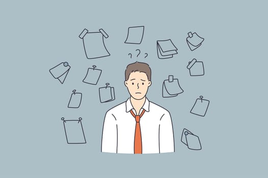 Having much work and duties concept. Young stressed man worker cartoon character standing feeling frustrated with variety of notes papers on wall vector illustration