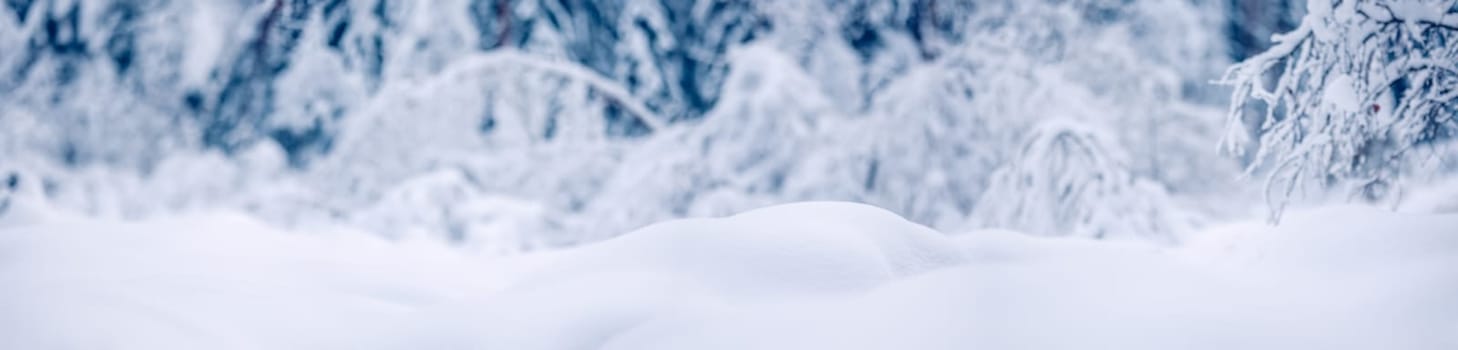Snowy background with closeup view of the wavy snowdrifts. Concept of the wallpaper, background and backdrop.