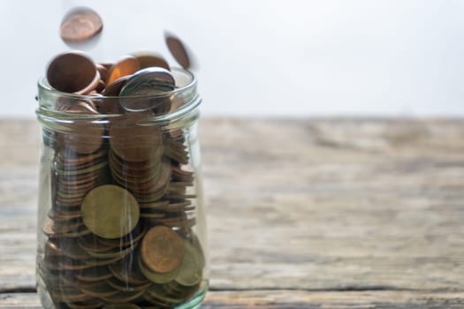 Save money and account banking for finance concept, Hand with coin on blurred background