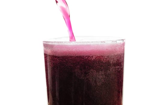 Solt drink being poures into a glass with ice