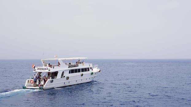 Egypt, Sharm El Sheikh - September 20, 2019: Tourist cruise boat with tourists in the Red Sea. Landscape of the Red Sea. White yachts await tourists in the azure waters of Egypt