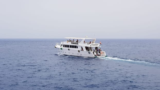 Egypt, Sharm El Sheikh - September 20, 2019: Tourist cruise boat with tourists in the Red Sea. Landscape of the Red Sea. White yachts await tourists in the azure waters of Egypt