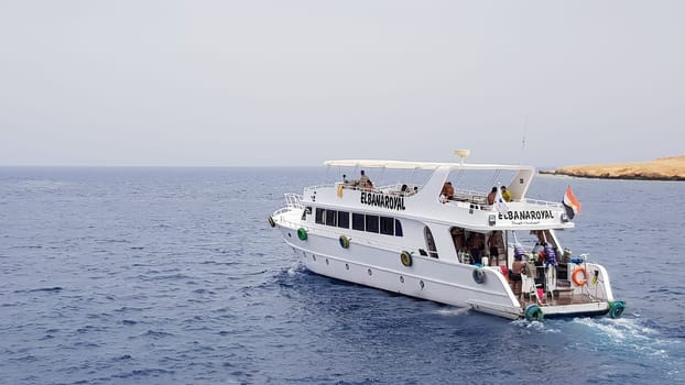 Egypt, Sharm El Sheikh - September 20, 2019: Tourist cruise boat with tourists in the Red Sea. Landscape of the Red Sea. White yachts await tourists in the azure waters of Egypt