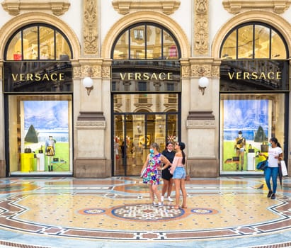 MILAN, ITALY - CIRCA SEPTEMBER 2020: Fashion shopping in Vittorio Emanuale's Gallery. People walking in front of a famous luxury boutique.