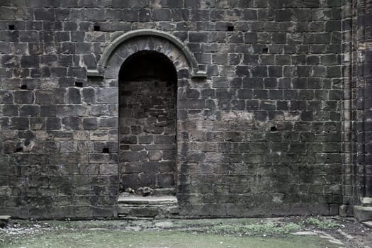 A bricked up doorway in an old gothic building