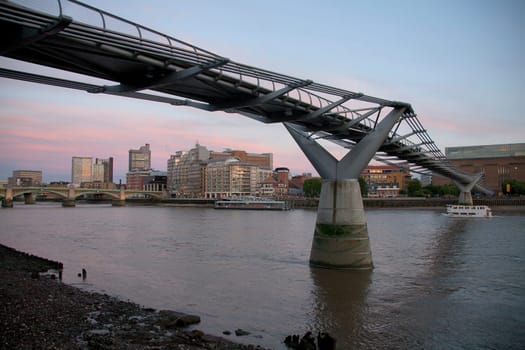 The River Thames and the Millennium Bridge at dusk London UK
