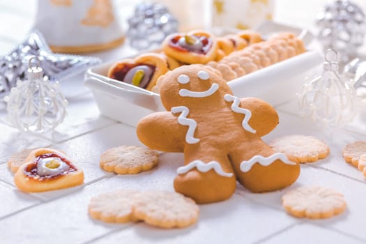 Homemade Christmas cookies and gingerbread with ornaments in white