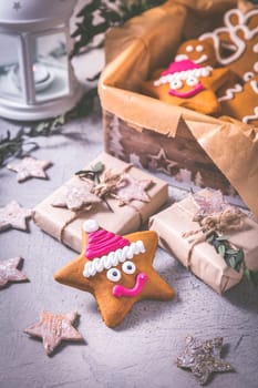 Gingerbread cookies for Christmas in cookie box with stars and small presents