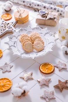 Christmas time, homemade cookies with ornaments and winter decorations in white