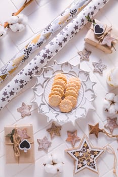 Christmas time, homemade cookies with ornaments and winter decorations in white