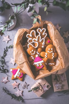 Gingerbread cookies for Christmas in cookie box with stars and small presents