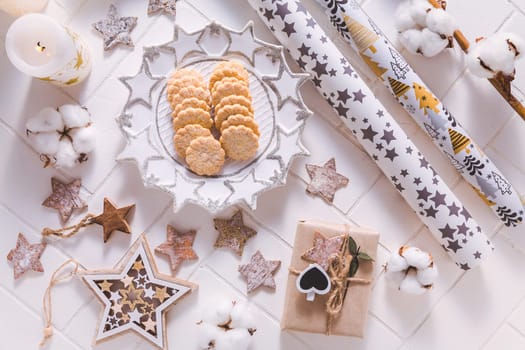 Christmas time, homemade cookies with ornaments and winter decorations in white