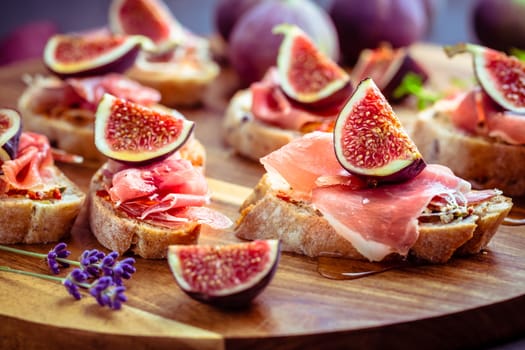 Small open sandwiches with ciabatta, proscuitto and fresh figs as appetizes