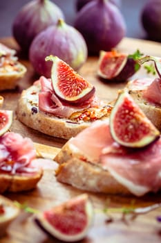 Small open sandwiches with ciabatta, proscuitto and fresh figs as appetizes