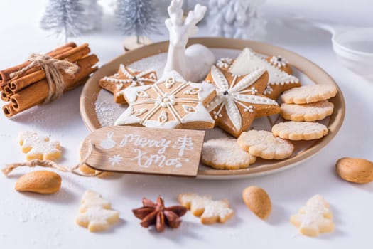 Homemade Christmas cookies with ornaments in white