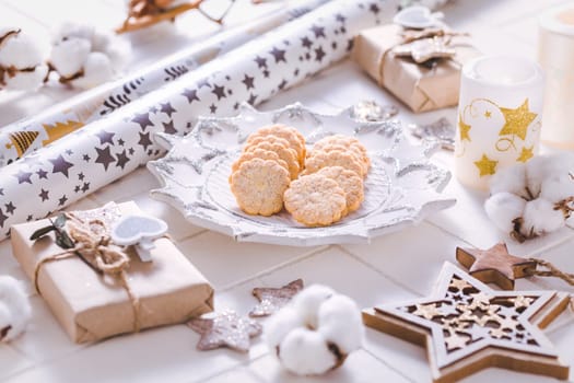 Christmas time, homemade cookies with ornaments and winter decorations in white