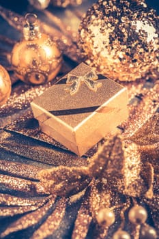 Christmas ornaments with small present in golden tones