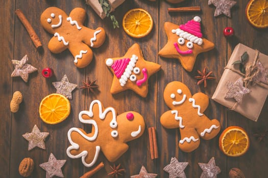 Gingerbread cookies with traditional spices for Christmas time on wooden table