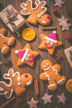 Gingerbread cookies with traditional spices for Christmas time on wooden table