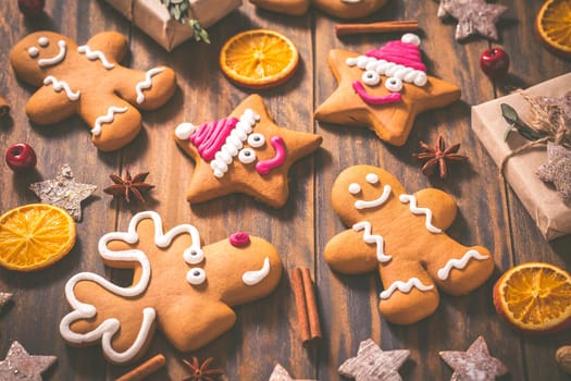 Gingerbread cookies with traditional spices for Christmas time on wooden table