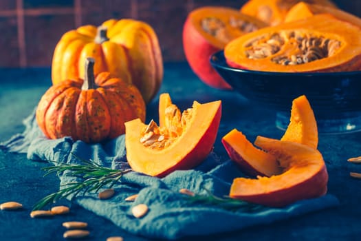 Organic pumpkin with seeds ready for cooking on blue background