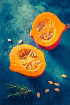 Organic pumpkin with seeds ready for cooking on blue background