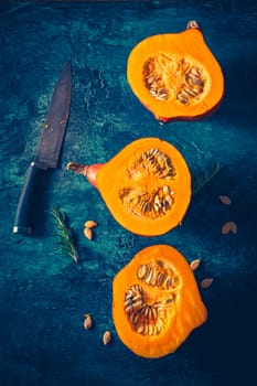 Organic pumpkin with seeds ready for cooking on blue background