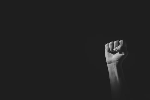 Fist pose hand with light and shadow, black an white, isolated on black