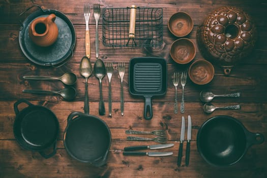 Assortment of vintage kitchen utensils on wooden table