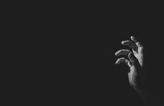 Hand with light and shadow, black an white, isolated on black