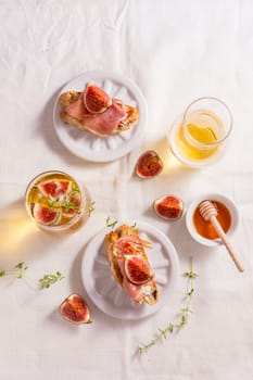 Small canape snack, crostini with ham, fig and apple wine, Italian antipasti