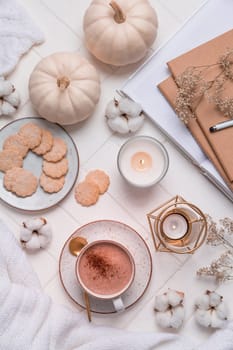 Autumn and winter still life with hot chocolate and cocoa, cookies, candles in white