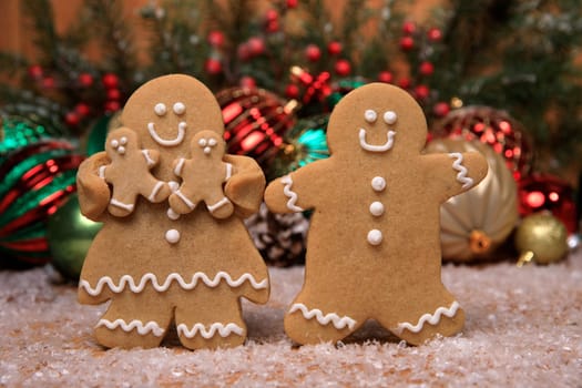 Gingerbread Family of 2 kids on Holiday Christmas Background