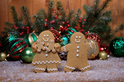 Gingerbread Family of 2 kids on Holiday Christmas Background