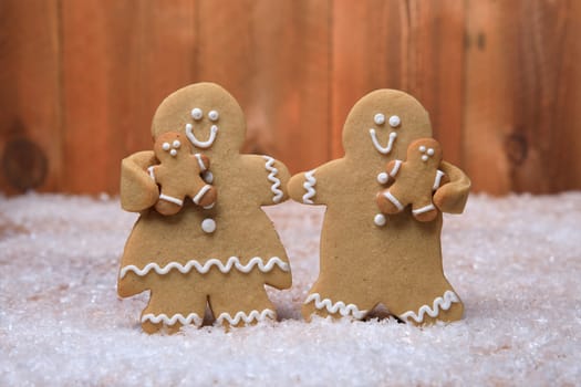 Gingerbread Family of 2 kids on Holiday Christmas Background