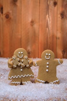 Gingerbread Family of 2 kids on Holiday Christmas Background