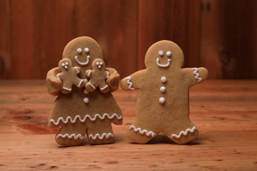 Gingerbread Family of 2 kids on Holiday Christmas Background