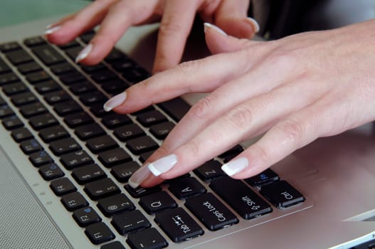 the woman is typing on the computer