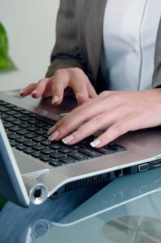the woman is typing on the computer