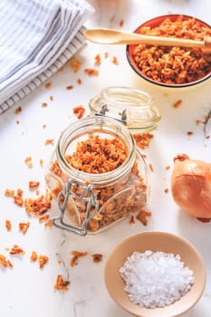 Making homemade fried onions with ingredients on white kitchen table