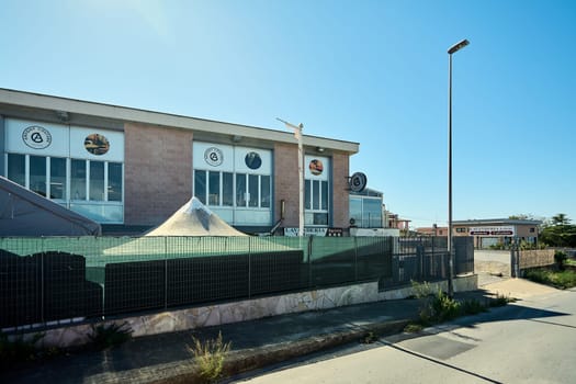 Civitavecchia. Italy - January 26, 2025: Industrial laundry facility with clear signage and modern architecture. Concept: services, urban infrastructure, and business operation.