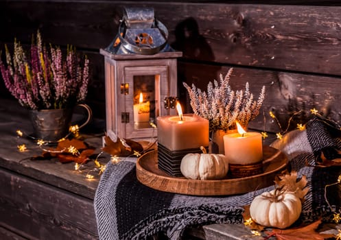 Beautiful autumn terrace decoration with pumpkins, lantern, plants and flowers