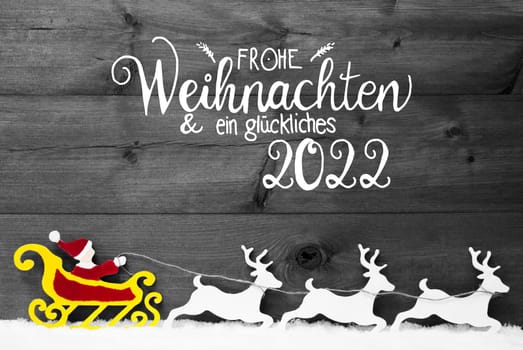 German Calligraphy Frohe Weihnachent Und Ein Glueckliches 2022 Means Merry Christmas And Happy 2022. Santa Claus With Sleigh And Reindeers. Gray Wooden Background With Snow