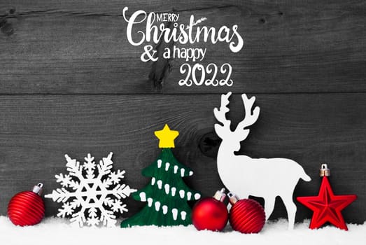 English Calligraphy Merry Christmas And Happy 2022. Red Christmas Decoration Like Ball, Reindeer, Tree And Snowflake. Gray Wooden Background With Snow