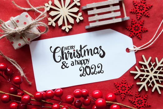 One Label With English Calligraphy Merry Christmas And A Happy 2022. Bright Red Christmas Deocration Like Sled, Present And Snowlfakes