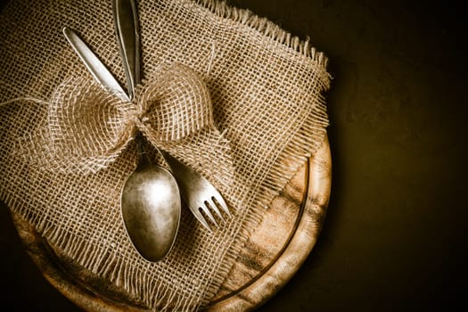 Vintage tableware, cutlery with wooden cutting board with retro effect