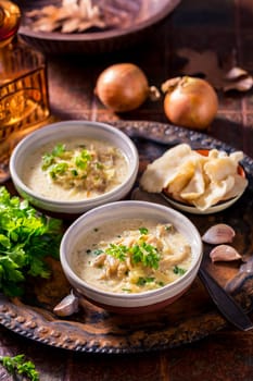 Vegan cabbage soup with oyster mushrooms with vegetables on old kitchen table