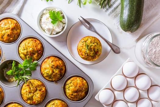 Homemade zucchini muffins with feta cheese, savory courgette with ingredients