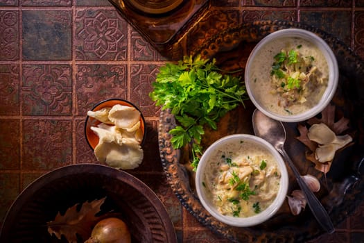 Vegan cabbage soup with oyster mushrooms with vegetables on old kitchen table