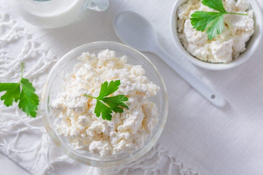 Dairy product - curd or cottage cheese, quark in bowl and milk on white background